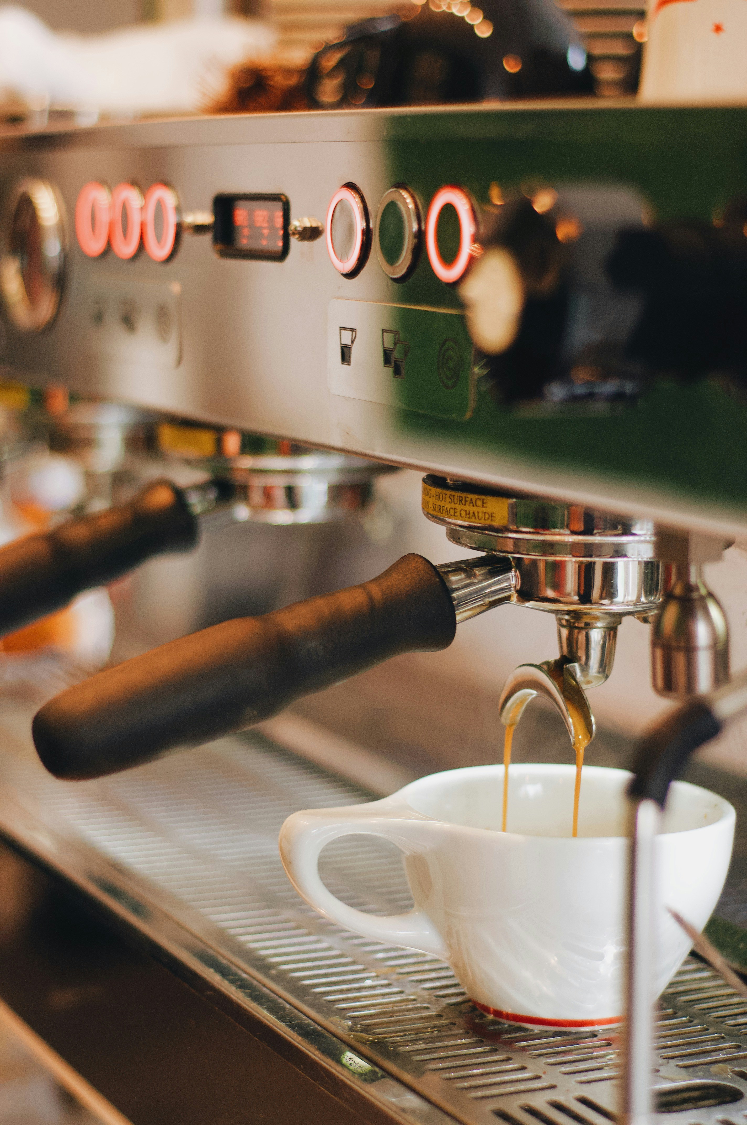 Espresso machine pulling a shot into a white cup